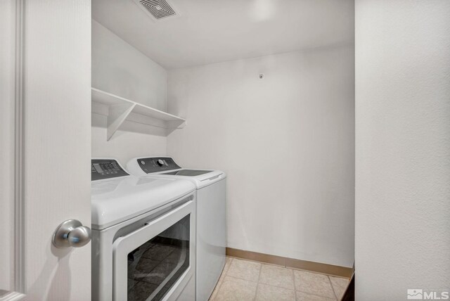 6850 Sharlands Ave Unit A2003, Reno, NV 89523 - laundry area featuring separate washer and dryer, baseboards, and light tile patterned floors