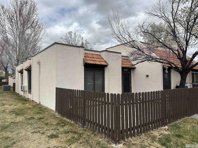 1020 Baywood Dr Unit B, Sparks, NV 89434 - view of property exterior with stucco siding, cooling unit, fence, and a tile roof