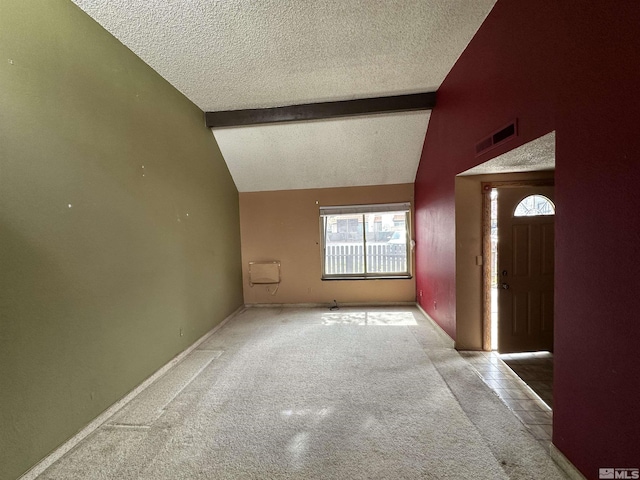 1020 Baywood Dr Unit B, Sparks, NV 89434 - unfurnished living room featuring a textured ceiling, beamed ceiling, plenty of natural light, carpet, and baseboards
