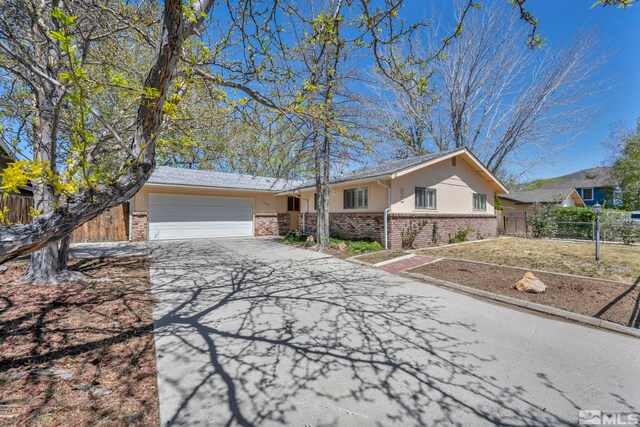 1308 Fremont, Carson City, NV 89701 - single story home with brick siding, an attached garage, driveway, and fence