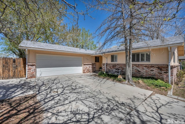 1308 Fremont, Carson City, NV 89701 - ranch-style house with brick siding, driveway, a garage, and fence
