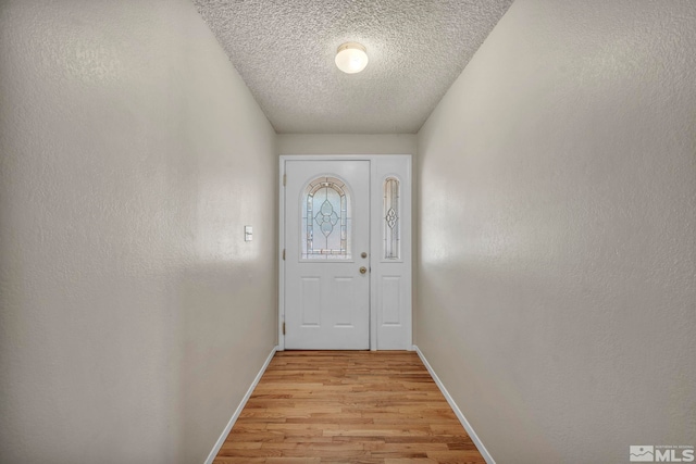 1308 Fremont, Carson City, NV 89701 - entryway featuring light wood-style floors, baseboards, and a textured ceiling