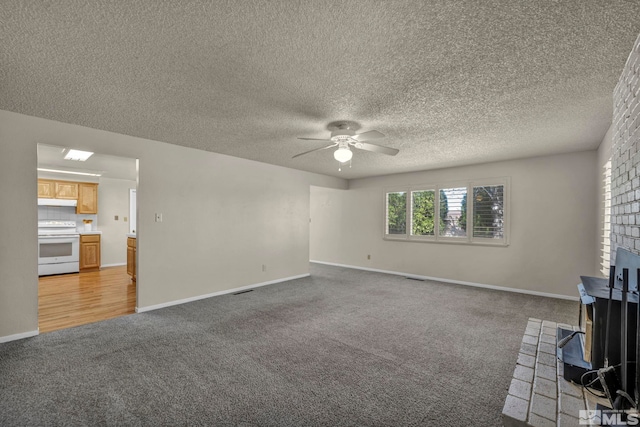 1308 Fremont, Carson City, NV 89701 - unfurnished living room with a wood stove, light colored carpet, ceiling fan, baseboards, and a textured ceiling
