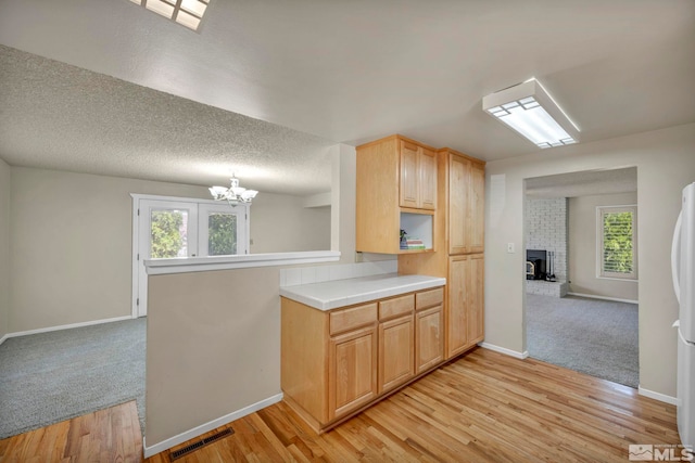 1308 Fremont, Carson City, NV 89701 - kitchen featuring a chandelier, plenty of natural light, baseboards, and a fireplace