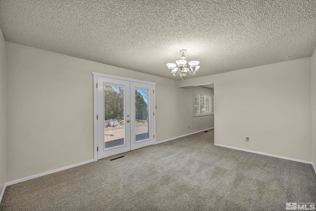 1308 Fremont, Carson City, NV 89701 - spare room with a chandelier, carpet floors, french doors, baseboards, and a textured ceiling