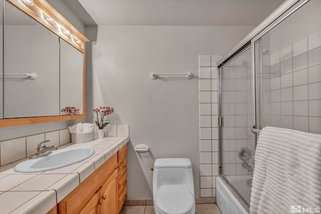 1308 Fremont, Carson City, NV 89701 - full bath with combined bath / shower with glass door, toilet, vanity, tasteful backsplash, and baseboards