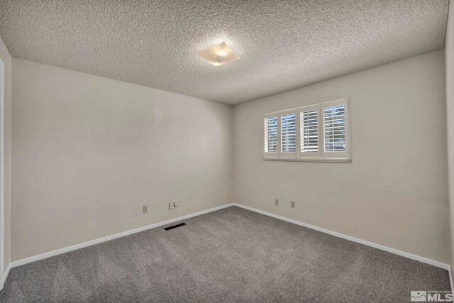 1308 Fremont, Carson City, NV 89701 - empty room featuring carpet flooring, a textured ceiling, and baseboards