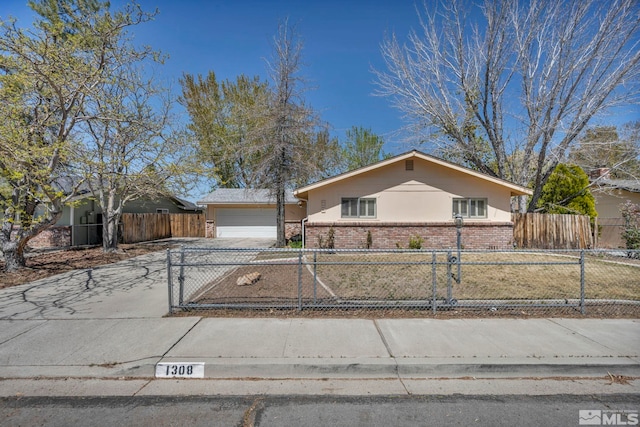 1308 Fremont, Carson City, NV 89701 - ranch-style house with brick siding, driveway, a fenced front yard, and a garage