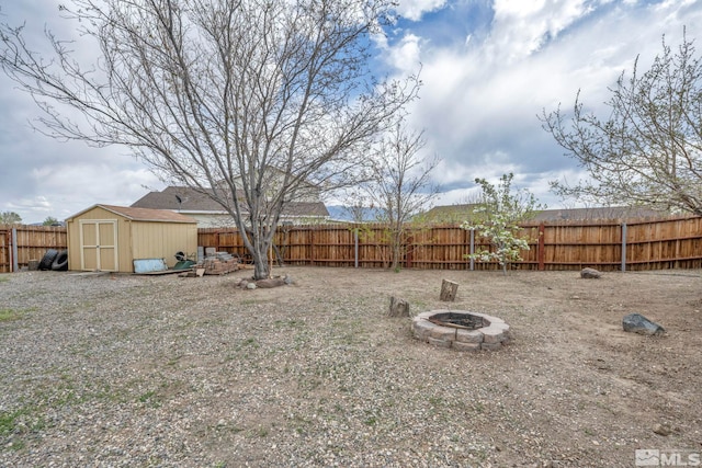 215 Red Wing Dr, Dayton, NV 89403 - fenced backyard with an outdoor fire pit, a shed, and an outdoor structure
