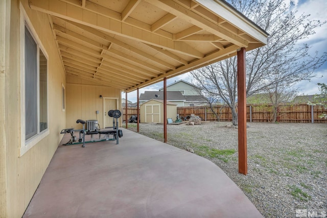 215 Red Wing Dr, Dayton, NV 89403 - view of patio / terrace featuring a storage unit, a fenced backyard, and an outbuilding