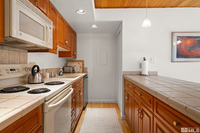 123 Juanita Dr Unit 2, Incline Village, NV 89451 - kitchen featuring white appliances, brown cabinetry, a sink, light wood-type flooring, and recessed lighting