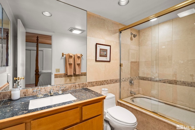 123 Juanita Dr Unit 2, Incline Village, NV 89451 - bathroom with tile walls, toilet, shower / bath combination with glass door, and vanity