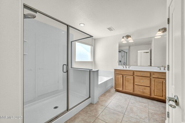 1144 Spruce Meadows Dr, Sparks, NV 89441 - bathroom with a stall shower, double vanity, a garden tub, tile patterned flooring, and a textured ceiling