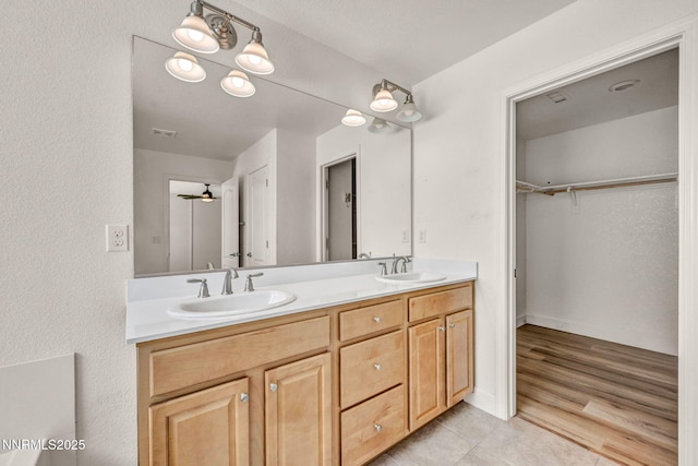 1144 Spruce Meadows Dr, Sparks, NV 89441 - bathroom featuring double vanity, tile patterned floors, and a walk in closet