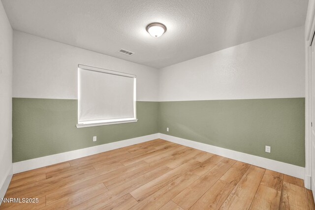 1144 Spruce Meadows Dr, Sparks, NV 89441 - spare room with wood finished floors and a textured ceiling