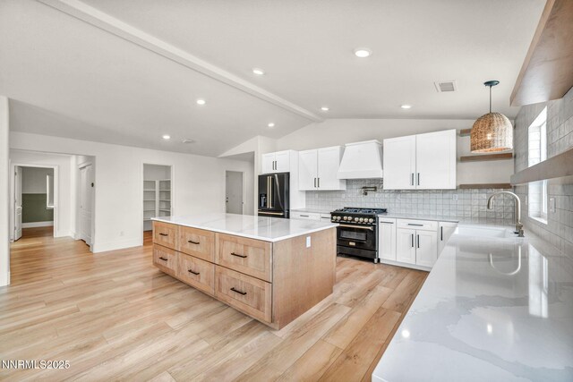 1144 Spruce Meadows Dr, Sparks, NV 89441 - kitchen with high end appliances, custom exhaust hood, open shelves, vaulted ceiling, and backsplash