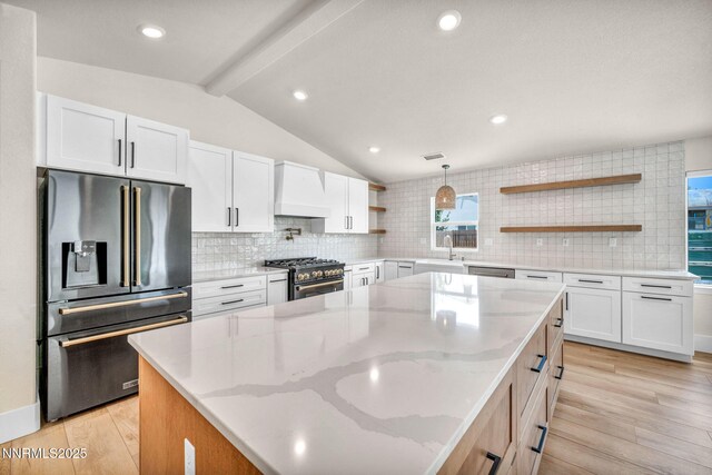 1144 Spruce Meadows Dr, Sparks, NV 89441 - kitchen featuring high quality appliances, open shelves, premium range hood, decorative backsplash, and a kitchen island