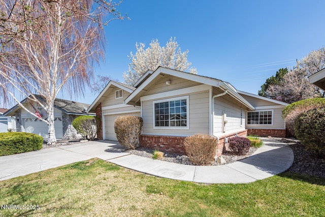 1774 Evergreen Ct, Minden, NV 89423 - ranch-style house with brick siding, an attached garage, concrete driveway, and a front yard