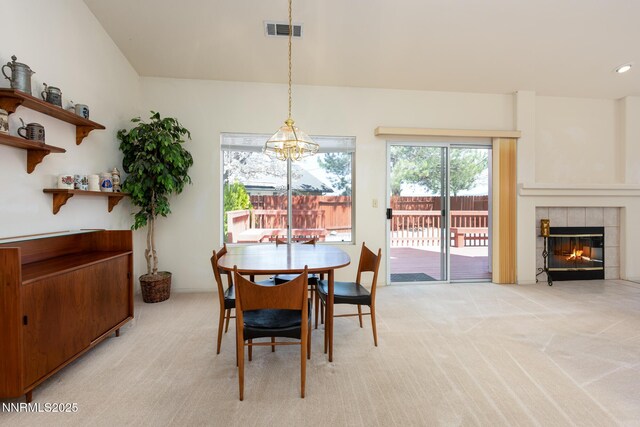 1774 Evergreen Ct, Minden, NV 89423 - dining area with light carpet and a tiled fireplace