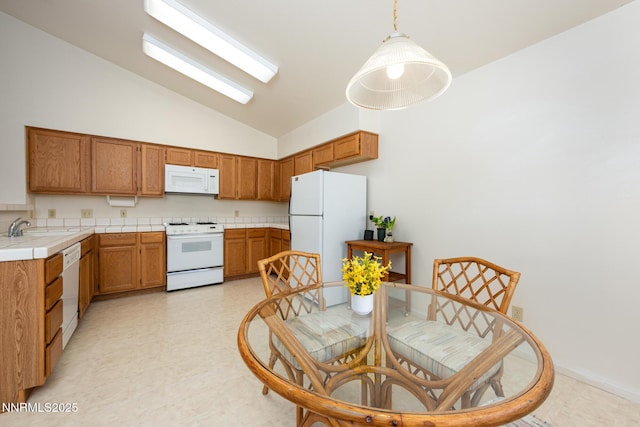 1774 Evergreen Ct, Minden, NV 89423 - kitchen featuring white appliances, brown cabinets, light floors, tile countertops, and pendant lighting