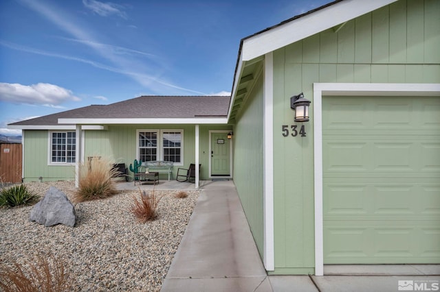 534 Dutch Oven Ct, Fernley, NV 89408 - doorway to property featuring a garage and roof with shingles