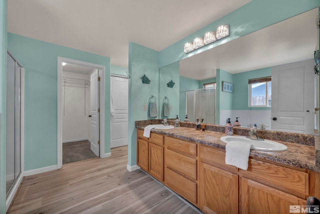 534 Dutch Oven Ct, Fernley, NV 89408 - bathroom with a stall shower, wood finished floors, double vanity, and baseboards