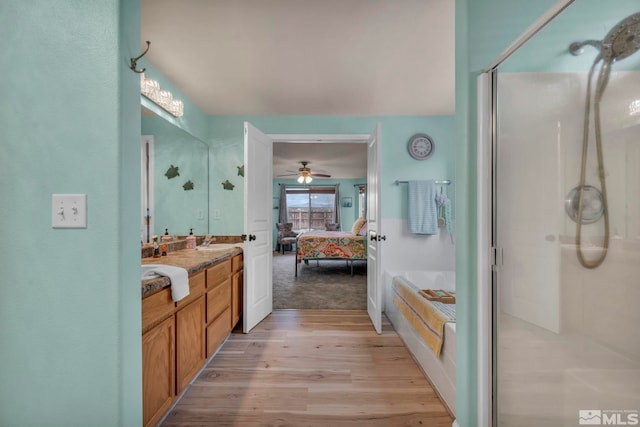 534 Dutch Oven Ct, Fernley, NV 89408 - bathroom featuring wood finished floors, ensuite bath, a stall shower, vanity, and a ceiling fan