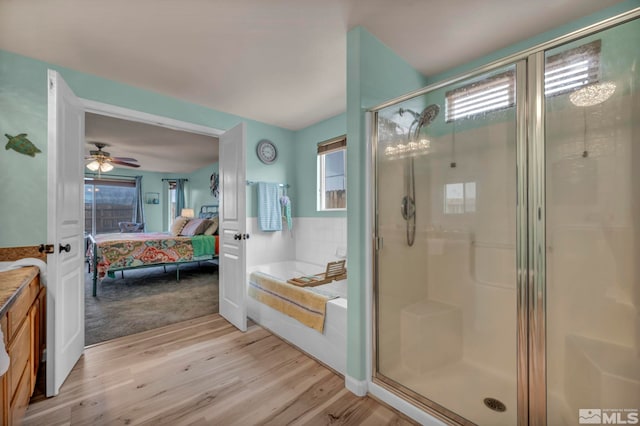 534 Dutch Oven Ct, Fernley, NV 89408 - ensuite bathroom featuring wood finished floors, a stall shower, a bath, and ceiling fan