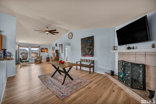 534 Dutch Oven Ct, Fernley, NV 89408 - living room featuring a tiled fireplace, a ceiling fan, lofted ceiling, light wood-style flooring, and baseboards
