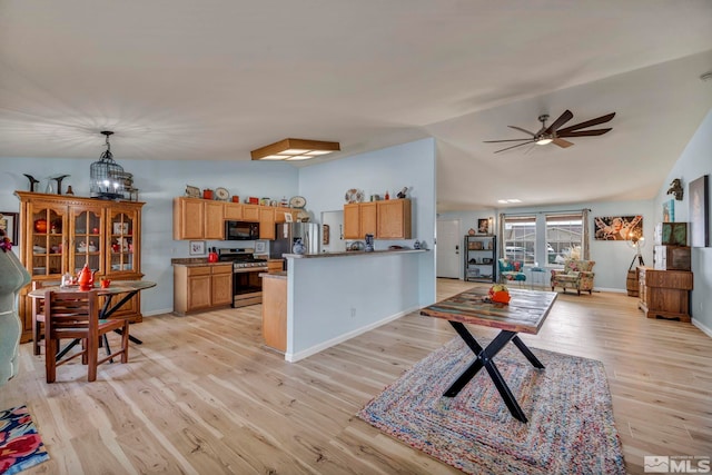 534 Dutch Oven Ct, Fernley, NV 89408 - kitchen featuring stainless steel appliances, light wood finished floors, a peninsula, vaulted ceiling, and ceiling fan