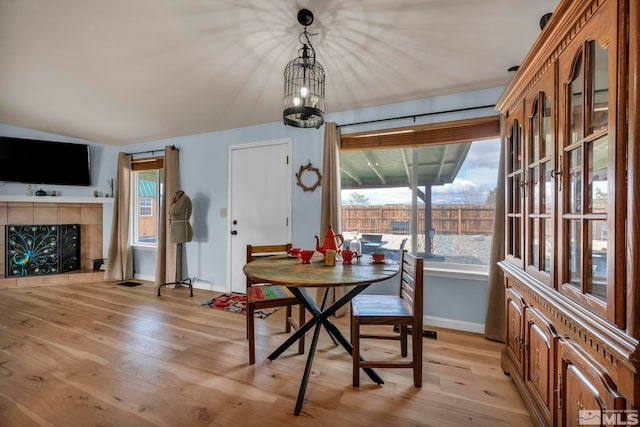 534 Dutch Oven Ct, Fernley, NV 89408 - dining room with baseboards, light wood finished floors, and a tile fireplace