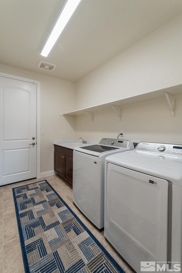 1023 Carico Valley Pl, Sparks, NV 89441 - clothes washing area featuring cabinet space, separate washer and dryer, light tile patterned floors, and baseboards
