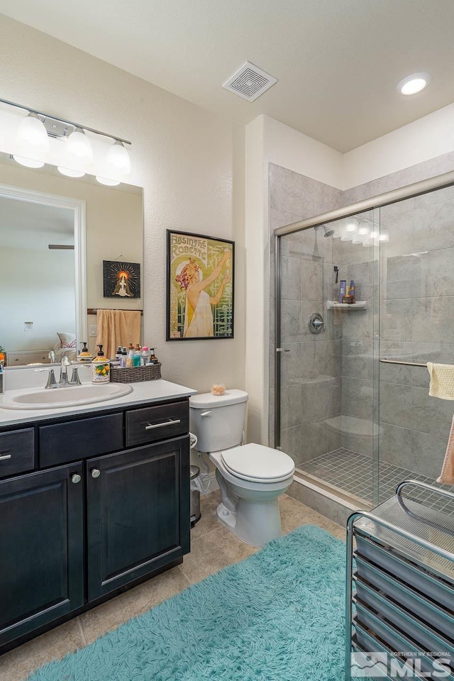 1023 Carico Valley Pl, Sparks, NV 89441 - bathroom featuring a stall shower, vanity, toilet, and tile patterned flooring