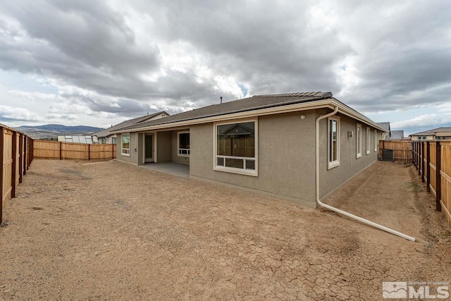 1023 Carico Valley Pl, Sparks, NV 89441 - back of property featuring a fenced backyard, stucco siding, and a patio