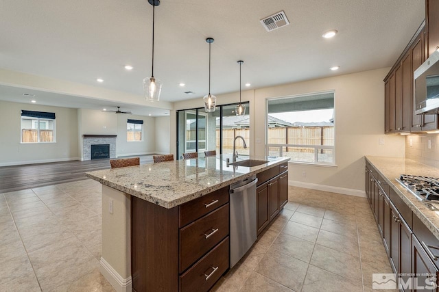 1023 Carico Valley Pl, Sparks, NV 89441 - kitchen featuring appliances with stainless steel finishes, a sink, baseboards, light tile patterned floors, and recessed lighting
