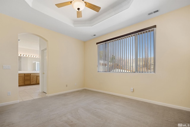 2761 Cheshire, Reno, NV 89523 - spare room with arched walkways, light carpet, a tray ceiling, ceiling fan, and baseboards
