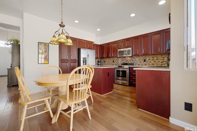 2761 Cheshire, Reno, NV 89523 - kitchen featuring stainless steel appliances, dark brown cabinets, light countertops, decorative backsplash, and a center island