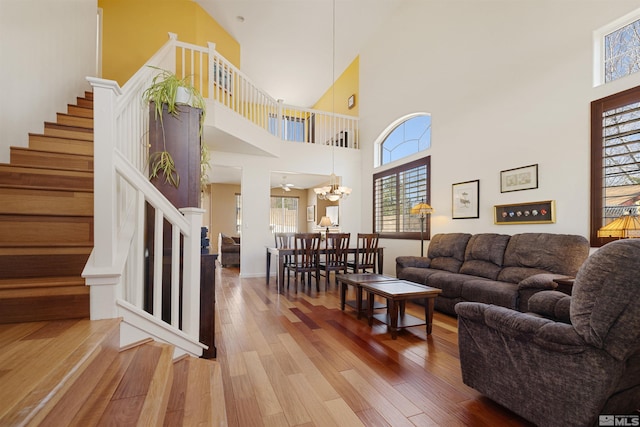 2761 Cheshire, Reno, NV 89523 - living room featuring hardwood / wood-style floors, stairway, a chandelier, and a towering ceiling
