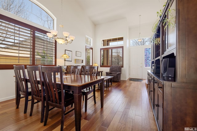 2761 Cheshire, Reno, NV 89523 - dining space featuring a chandelier, a towering ceiling, wood finished floors, and baseboards