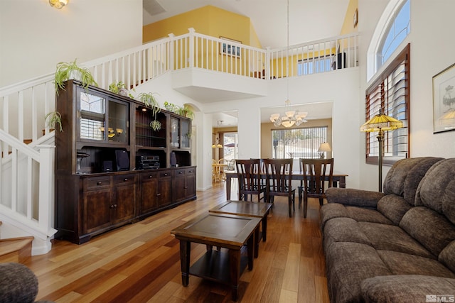 2761 Cheshire, Reno, NV 89523 - living area with stairs, wood-type flooring, a chandelier, and a high ceiling
