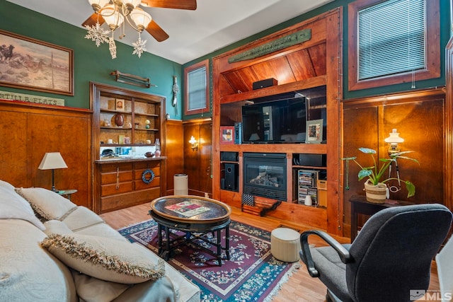 2640 Emily St, Reno, NV 89503 - living room featuring ceiling fan, wood finished floors, a wainscoted wall, a glass covered fireplace, and wood walls