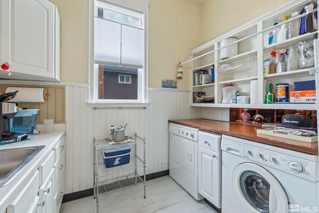 2640 Emily St, Reno, NV 89503 - washroom featuring cabinet space, a wainscoted wall, and light wood finished floors