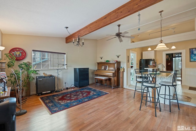 2640 Emily St, Reno, NV 89503 - living room featuring light wood-style flooring, radiator, beam ceiling, washer / clothes dryer, and ceiling fan