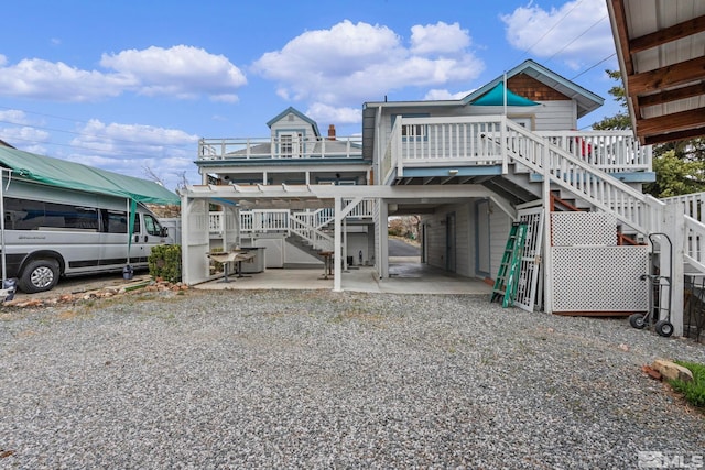 2640 Emily St, Reno, NV 89503 - rear view of property with stairway, a carport, gravel driveway, and a patio area