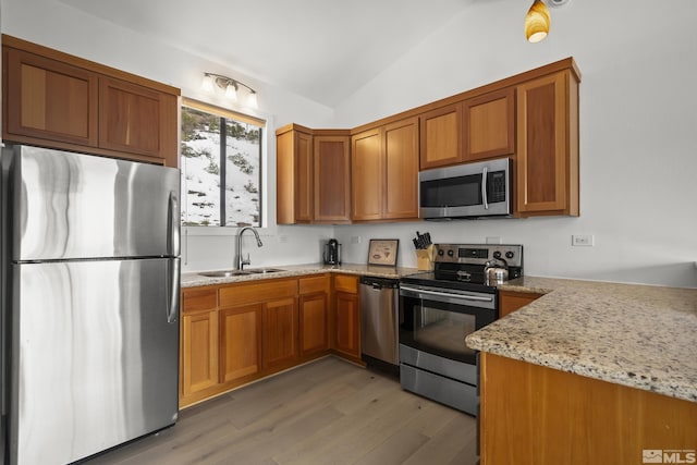 400 Fairview Blvd Unit 8, Incline Village, NV 89451 - kitchen featuring appliances with stainless steel finishes, a sink, brown cabinets, lofted ceiling, and light wood-type flooring