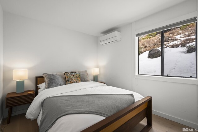 400 Fairview Blvd Unit 8, Incline Village, NV 89451 - bedroom featuring an AC wall unit, wood finished floors, and baseboards