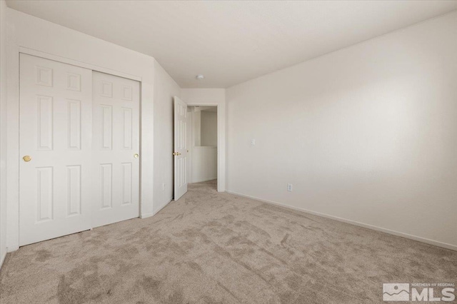 7753 Tulear St, Reno, NV 89506 - unfurnished bedroom featuring carpet, a closet, and baseboards