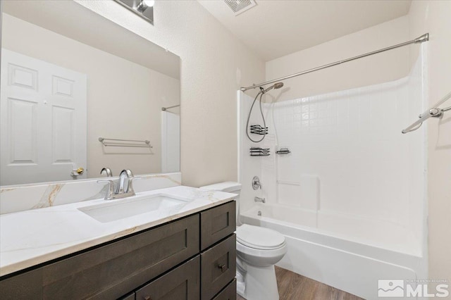 7753 Tulear St, Reno, NV 89506 - bathroom with toilet, wood finished floors, vanity, and washtub / shower combination
