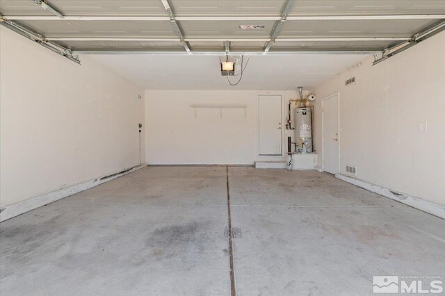 7753 Tulear St, Reno, NV 89506 - garage with gas water heater and a garage door opener
