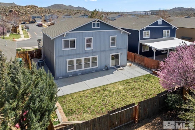 7753 Tulear St, Reno, NV 89506 - back of house featuring a fenced backyard, a patio, a mountain view, central AC, and a residential view